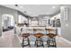 Modern kitchen with stainless steel appliances, sliding barn door to laundry, and breakfast bar seating at 9202 Brindlewood Dr, Odessa, FL 33556