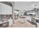 Spacious kitchen features white cabinetry, stainless steel appliances, an island with butcher block, and tile floors at 9202 Brindlewood Dr, Odessa, FL 33556