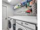 Well-organized laundry room with modern washer and dryer, complemented by functional shelving at 9202 Brindlewood Dr, Odessa, FL 33556