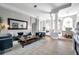 Open-concept living space with stylish furnishings, an accent wall, and seamless flow to other areas at 9202 Brindlewood Dr, Odessa, FL 33556