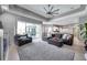 Bright living area with sliding glass doors leading to the screened-in lanai and open to the kitchen at 9202 Brindlewood Dr, Odessa, FL 33556