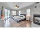 Inviting bedroom with a fireplace, patio access, and a soothing color palette at 9202 Brindlewood Dr, Odessa, FL 33556
