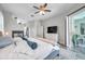 Inviting primary bedroom with fireplace, flat screen tv, and sliding doors to the patio at 9202 Brindlewood Dr, Odessa, FL 33556