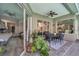 Covered patio with ceiling fan and sliding doors, overlooking the landscaped backyard at 9202 Brindlewood Dr, Odessa, FL 33556