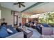 Relaxing covered patio with ample seating, complete with ceiling fan and view of backyard at 9202 Brindlewood Dr, Odessa, FL 33556