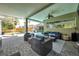 Inviting covered patio with cozy seating area, ideal for relaxation and enjoying the outdoors at 9202 Brindlewood Dr, Odessa, FL 33556