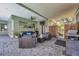 Spacious covered patio featuring comfortable seating and an outdoor kitchen at 9202 Brindlewood Dr, Odessa, FL 33556