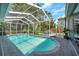 Large screened-in pool with a brick-paved deck and views of the backyard at 9202 Brindlewood Dr, Odessa, FL 33556
