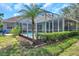 A lovely screened pool with an adjacent patio and landscaped yard at 9202 Brindlewood Dr, Odessa, FL 33556