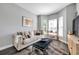 Cozy sitting room with comfortable seating, natural light, and stylish decor for relaxation at 9202 Brindlewood Dr, Odessa, FL 33556
