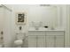 Bathroom featuring double vanity with marble countertops, modern fixtures, and tiled shower at 9497 Minnow Ray Dr, Land O Lakes, FL 34638