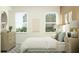 Comfortable bedroom with a queen bed, dresser, stylish decor, and plenty of natural light at 9497 Minnow Ray Dr, Land O Lakes, FL 34638
