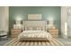 Elegant bedroom featuring a king bed, side tables, and designer lighting at 9497 Minnow Ray Dr, Land O Lakes, FL 34638