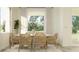 Charming dining room with seating for six, modern window blinds, and lots of natural light at 9497 Minnow Ray Dr, Land O Lakes, FL 34638