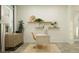 Bright home office design featuring floating shelves, modern decor, and natural light at 9497 Minnow Ray Dr, Land O Lakes, FL 34638