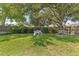 Lush backyard featuring a playhouse and a bench, perfect for outdoor activities and enjoying the serene environment at 10409 Glen Willow Ln, Tampa, FL 33647