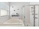 Bright bathroom featuring a soaking tub, glass shower, and a window letting in natural light at 10409 Glen Willow Ln, Tampa, FL 33647