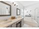 A bathroom featuring a double vanity, soaking tub, and glass-enclosed shower at 10409 Glen Willow Ln, Tampa, FL 33647