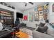 Comfortable bedroom with hardwood floors, large window, sofa, and a gaming setup at 10409 Glen Willow Ln, Tampa, FL 33647