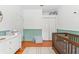 Well-lit Bedroom with wood floors, a crib, changing table, and ample closet space at 10409 Glen Willow Ln, Tampa, FL 33647