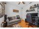 Inviting bedroom with hardwood floors, sofa, and a gaming chair and setup at 10409 Glen Willow Ln, Tampa, FL 33647