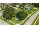 Aerial view of a neighborhood park with a playground, tennis courts, mature trees, and sidewalks for recreation at 10409 Glen Willow Ln, Tampa, FL 33647