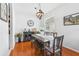 Elegant dining area with hardwood floors, stylish light fixture and modern decor at 10409 Glen Willow Ln, Tampa, FL 33647