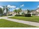 A well-maintained one story home with a large driveway, lush landscaping, and mature trees at 10409 Glen Willow Ln, Tampa, FL 33647