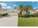 Charming single-story home features a well-manicured lawn, palm trees, and a two-car garage at 10409 Glen Willow Ln, Tampa, FL 33647