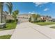 Beautiful one-story home with landscaped front yard, a two-car garage and a red front door at 10409 Glen Willow Ln, Tampa, FL 33647