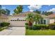 Charming single-Gathering home with a well-manicured lawn, mature trees, and a two-car garage at 10409 Glen Willow Ln, Tampa, FL 33647
