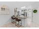 A large kitchen island with barstool seating, stainless appliances, and white cabinetry at 10409 Glen Willow Ln, Tampa, FL 33647