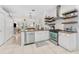 Bright kitchen featuring stainless steel appliances, granite countertops, and floating wooden shelves at 10409 Glen Willow Ln, Tampa, FL 33647