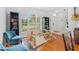 Bright living room with hardwood floors, large windows, and ample natural light at 10409 Glen Willow Ln, Tampa, FL 33647