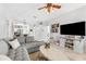 Cozy living room featuring a gray couch, tile flooring, and an open view to the kitchen at 10409 Glen Willow Ln, Tampa, FL 33647