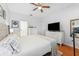 Spacious bedroom featuring hardwood floors, two dressers, and a large TV at 10409 Glen Willow Ln, Tampa, FL 33647