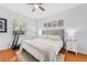 Bright main bedroom with hardwood floors, a window and a comfortable queen-sized bed at 10409 Glen Willow Ln, Tampa, FL 33647