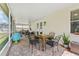 Spacious screened porch with a table, chairs, and a brick-paved floor at 10409 Glen Willow Ln, Tampa, FL 33647
