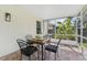 Relaxing screened porch with a dining table, chairs, and a brick floor at 10409 Glen Willow Ln, Tampa, FL 33647