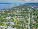Wide aerial view of a residential area, showing the property's location surrounded by lush greenery and neighborhood streets at 1136 Granada St, Clearwater, FL 33755