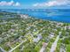 Aerial view of neighborhood close to the water with mature trees at 1136 Granada St, Clearwater, FL 33755