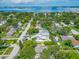 An aerial view showcases a charming neighborhood with views of the ocean at 1136 Granada St, Clearwater, FL 33755