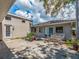 Enclosed backyard patio with outdoor seating, offering a private space for dining and enjoying the outdoor scenery at 1136 Granada St, Clearwater, FL 33755