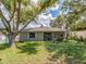 Charming single-story home with a well-maintained yard and mature shade trees at 1136 Granada St, Clearwater, FL 33755