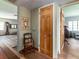 Hallway featuring wood floors, a brick wall, and doorways leading to other rooms at 1136 Granada St, Clearwater, FL 33755