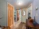 Hallway with wooden floors, doors, and trim, leading to other rooms in the home at 1136 Granada St, Clearwater, FL 33755