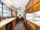 Charming kitchen featuring wood cabinets, a large window, and dining area, offering a cozy atmosphere at 1136 Granada St, Clearwater, FL 33755