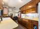 Cozy kitchen featuring wood cabinets and flooring, seamlessly flowing into an adjacent dining area at 1136 Granada St, Clearwater, FL 33755