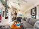 Bright living room with large windows and sliding doors, featuring comfortable seating and decor at 1136 Granada St, Clearwater, FL 33755