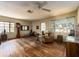 Bright living room with hardwood floors, exposed brick, and natural light, offering a comfortable and inviting space at 1136 Granada St, Clearwater, FL 33755